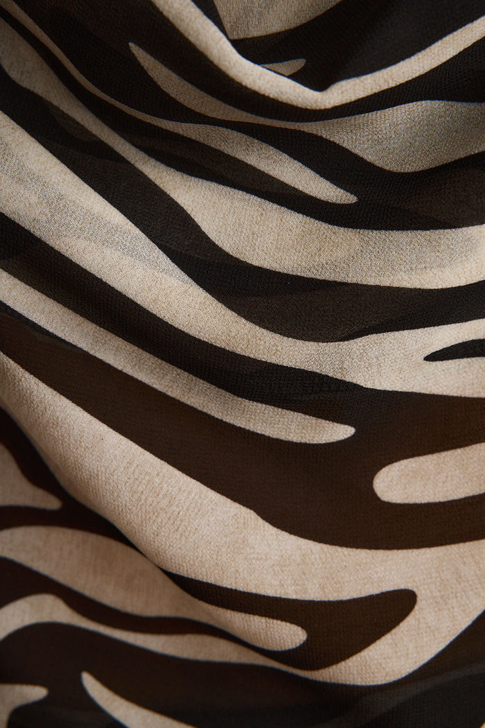 Lifestyle shot of the zebra print piece styled for day-to-night versatility.
