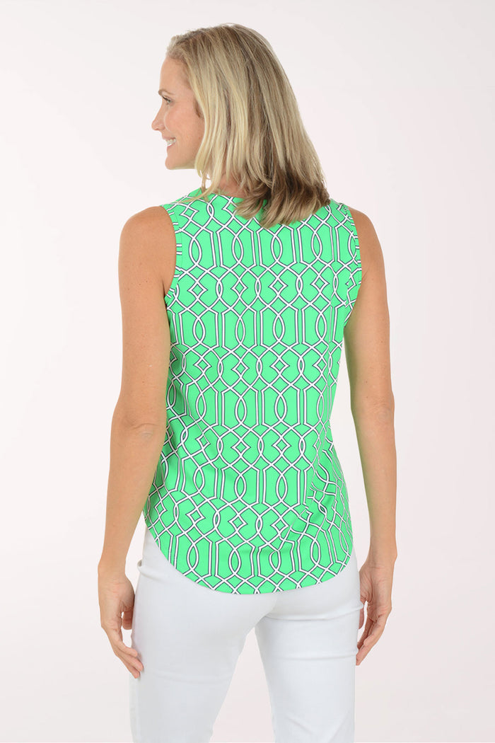 Woman wearing a green patterned sleeveless top on a white background