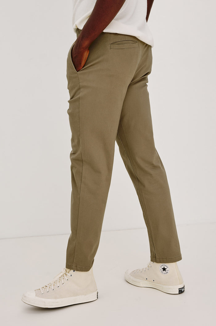 Julian Pant in Suede-Touch Stretch Cotton With Slim Straight Leg, Slightly Cropped Inseam, Elastic Waist, Side Slip Pockets, and Back Welt Pockets in Barley Colorway - Lower Body Side View Featured on Model