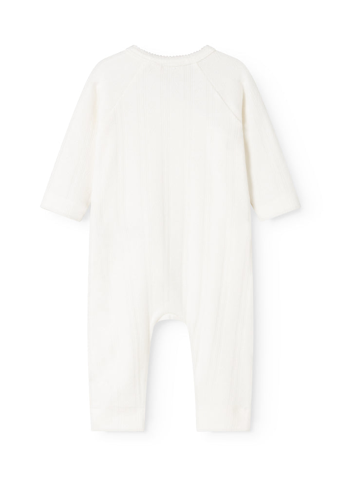 White baby jumpsuit with long sleeves and legs, round neckline.