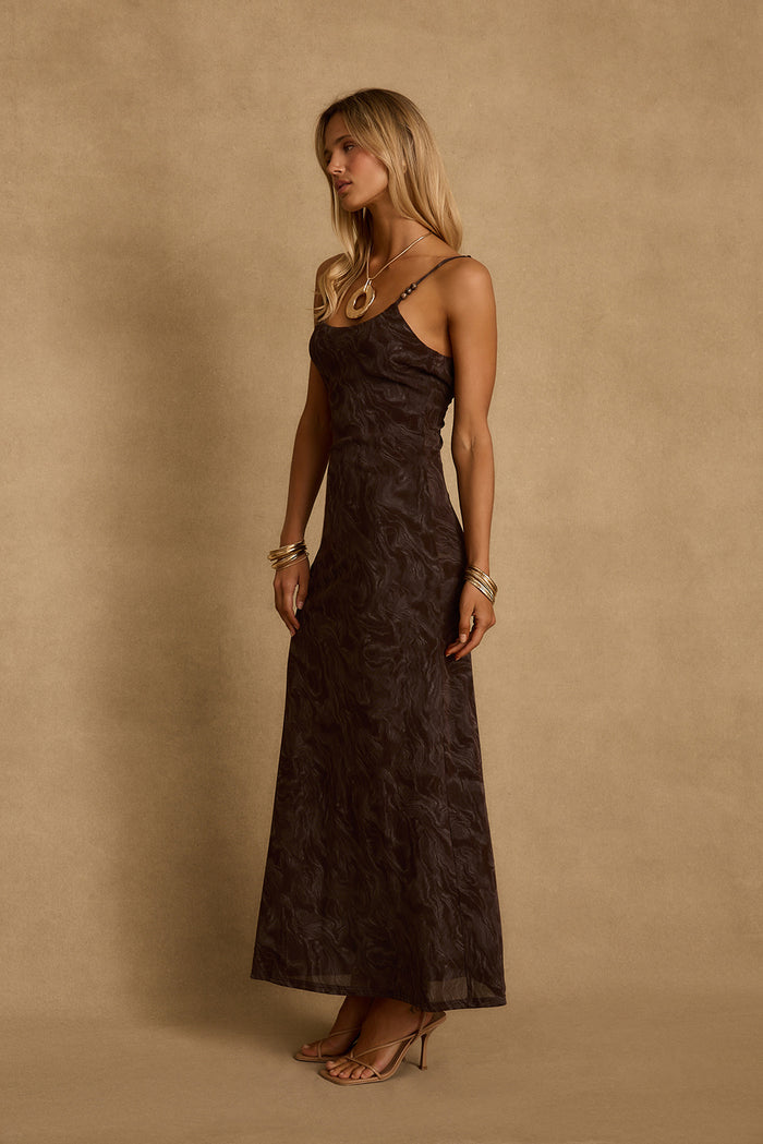 Side profile of the Amora mocha floral mesh maxi dress with beaded straps and gold bangles.