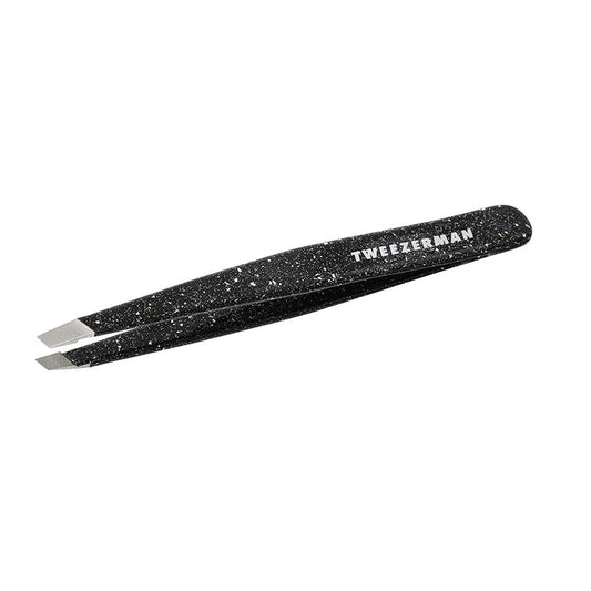 Anniversary Slant Tweezer | Tweezerman in black with a speckled design, featuring angled precision tips for effective eyebrow grooming and skincare routines.