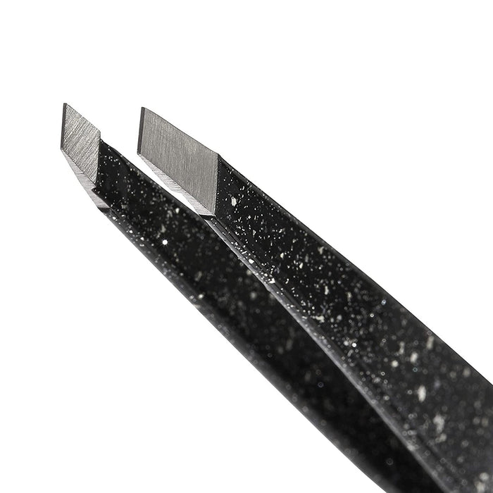 Close-up of angled precision tips on a black speckled Anniversary Slant Tweezer | Tweezerman, designed for accurate hair removal and skincare grooming.