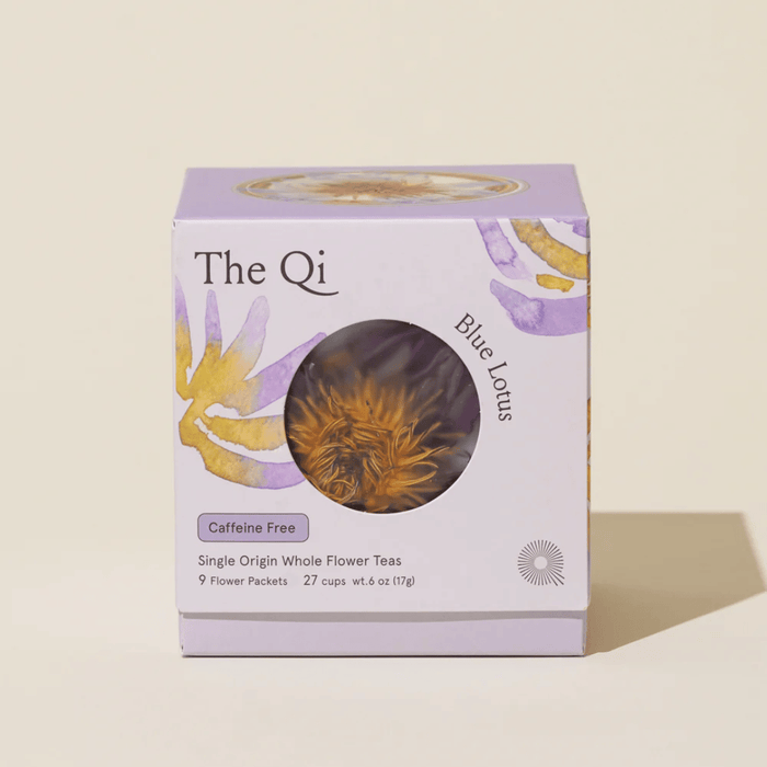 Box packaging of Blue Lotus Whole Flower Tea | The Qi featuring floral artwork, highlighting caffeine-free, single origin whole flower teas with 9 flower packets inside.