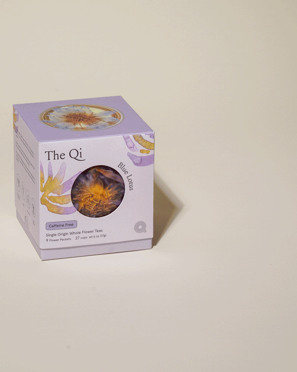 Packaging of Blue Lotus Whole Flower Tea | The Qi with a clear window showing dried blue lotus flower tea inside, displayed on a neutral background.