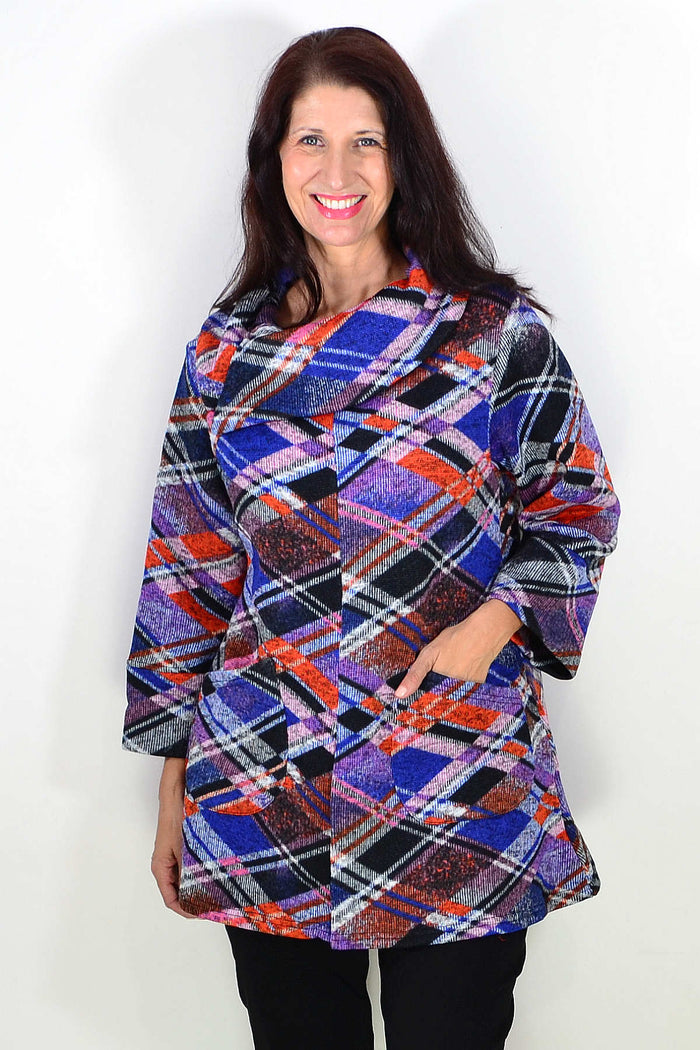 Blue and red geometric winter tunic top by Wishstone, featuring a stylish pattern and cozy fabric, displayed on a hanger.