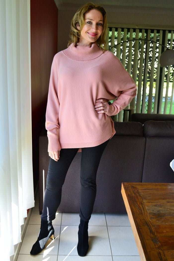 Blush pink Whishstone snuggle-up tunic jumper displayed on a hanger, featuring a cozy, relaxed fit and soft fabric.