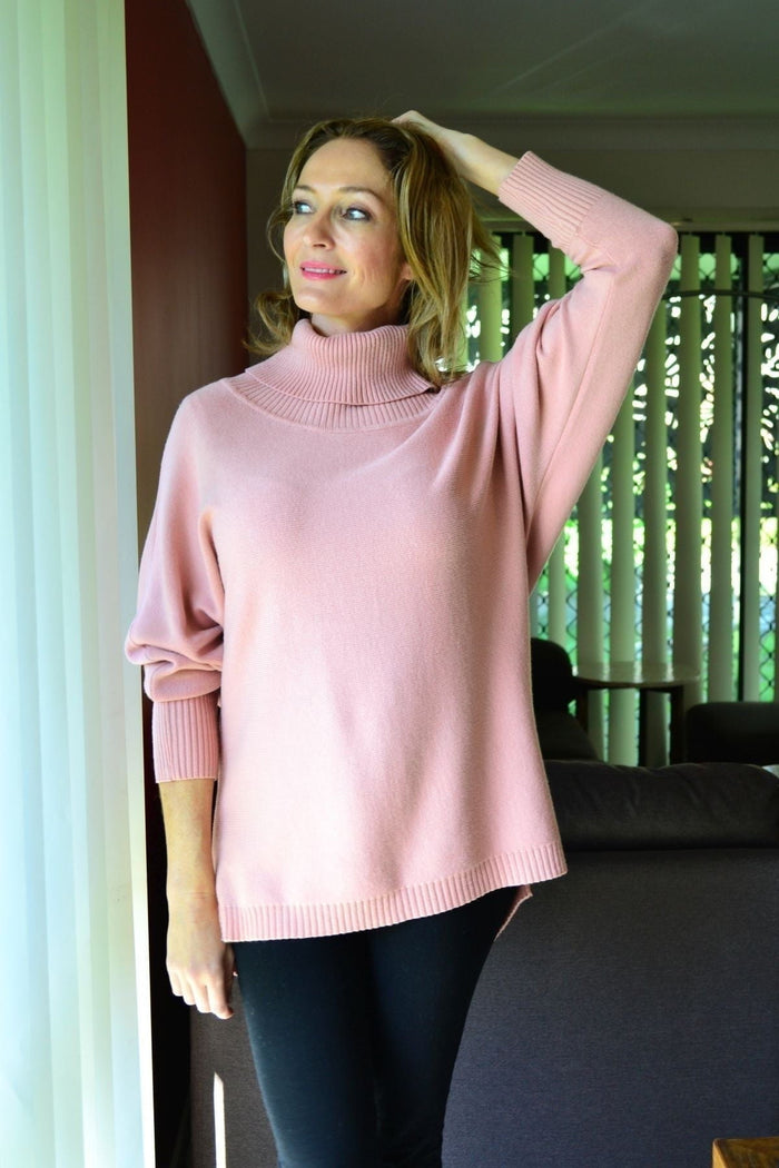 Blush pink Whishstone Snuggle Up Tunic Jumper displayed on a hanger with soft fabric and relaxed fit, perfect for casual wear.
