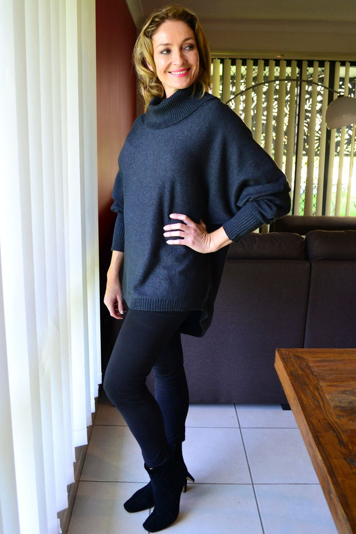 Charcoal grey Whishstone Snuggle Up Tunic Jumper displayed on a hanger, showcasing a cozy, relaxed fit with a soft knit texture.