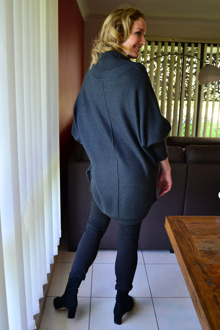 Charcoal grey Whishstone Snuggle Up Tunic Jumper displayed on a model, featuring a cozy, relaxed fit and soft fabric.