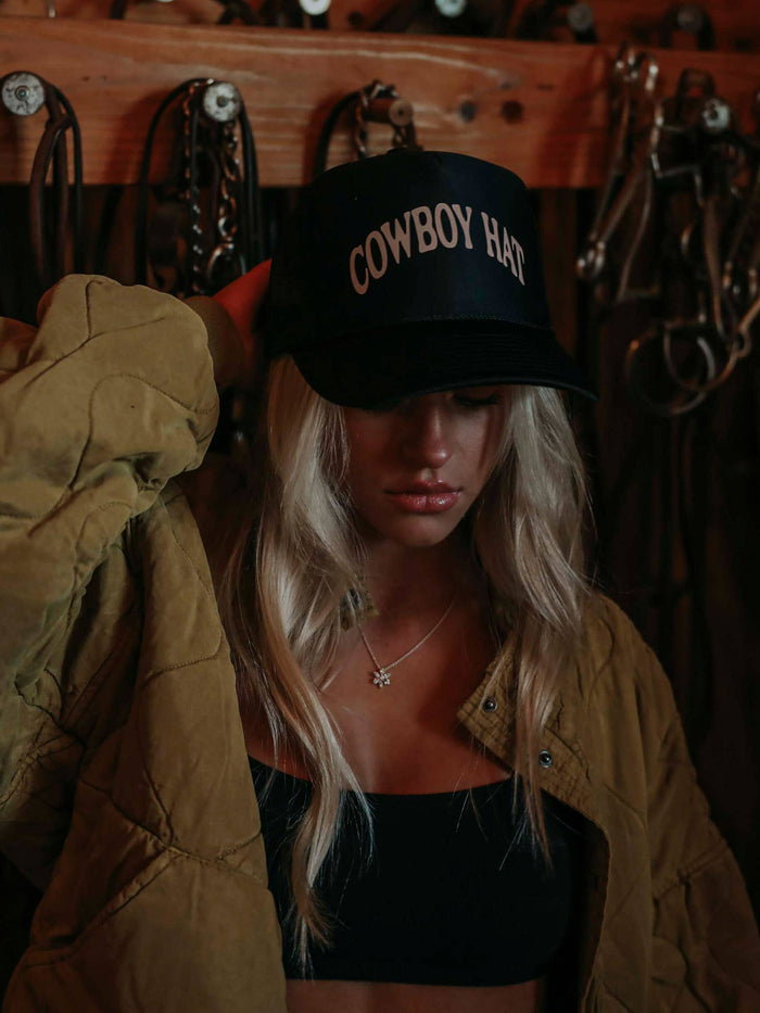 Woman wearing a black Cowboy Hat hat.
