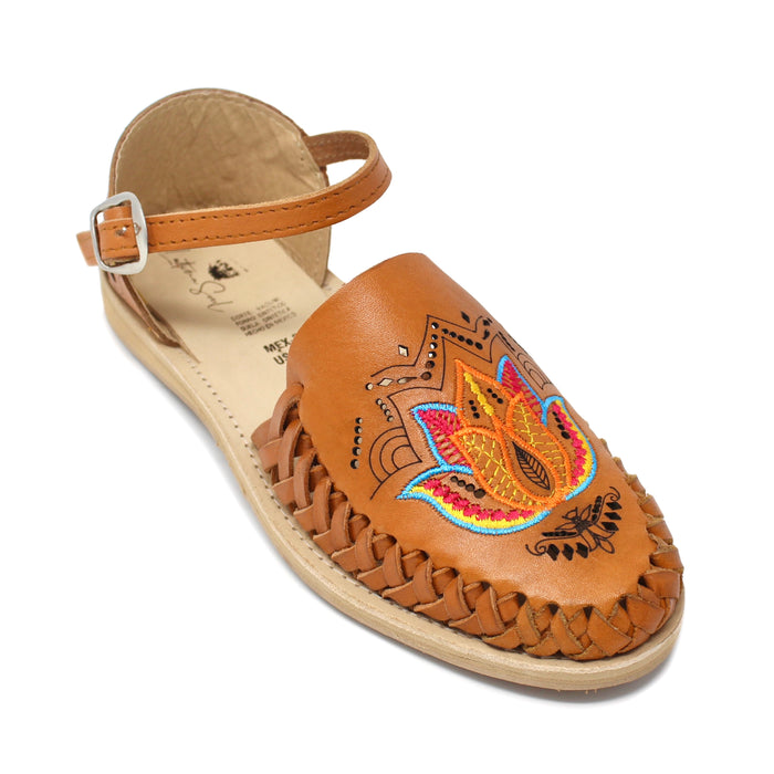 Women's handmade genuine leather huarache sandals featuring colorful floral embroidery, woven leather detailing, adjustable ankle buckle strap, cushioned leather footbed, and authentic artisan craftsmanship made in Mexico.