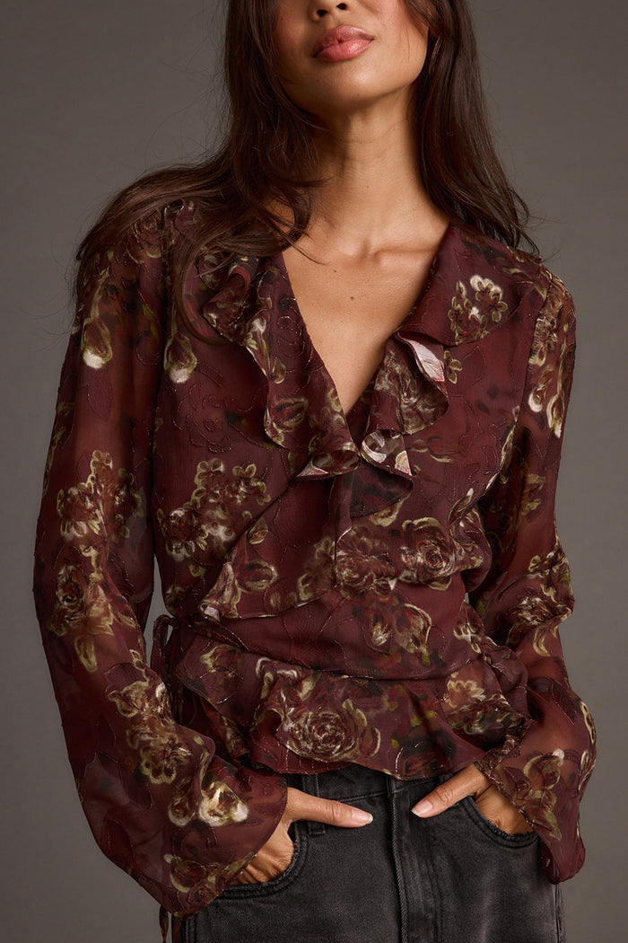 Plum blouse with refined detailing and a flattering silhouette.