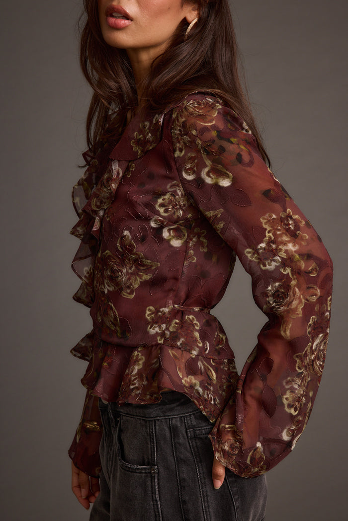 Back view of the plum blouse showing the silhouette and fit.