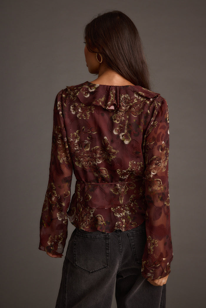 Close-up of the Dominique Plum Floral Blouse showcasing the fabric texture and design details.