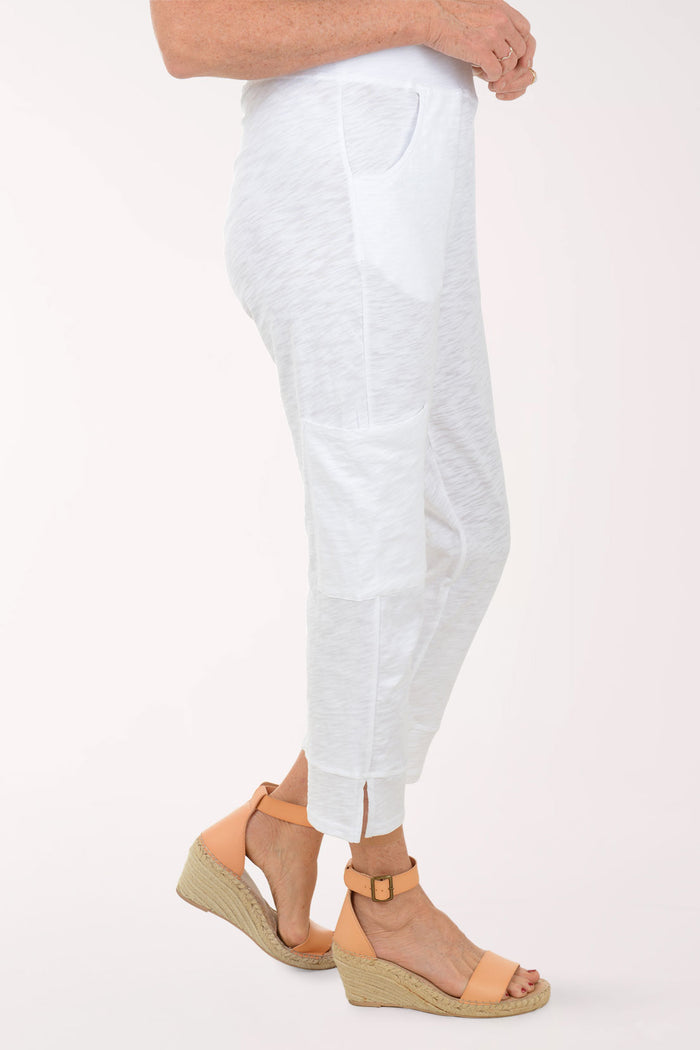White pants worn by a person on a white background