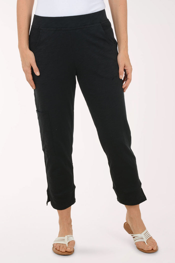 A woman wearing black capri pants.