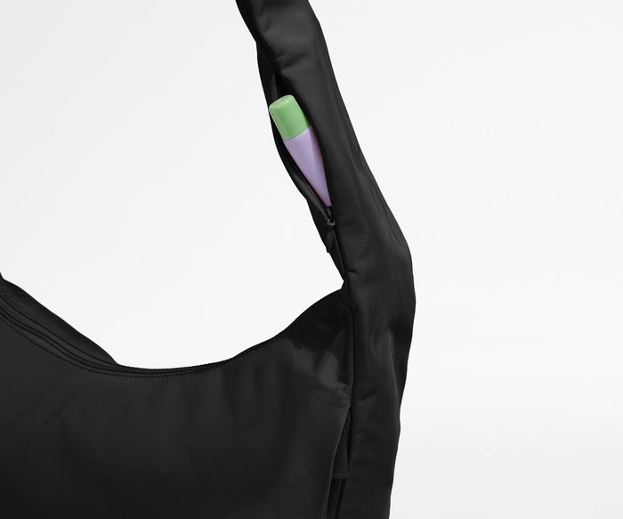 Chapstick in the discreet, zippered strap pocket
