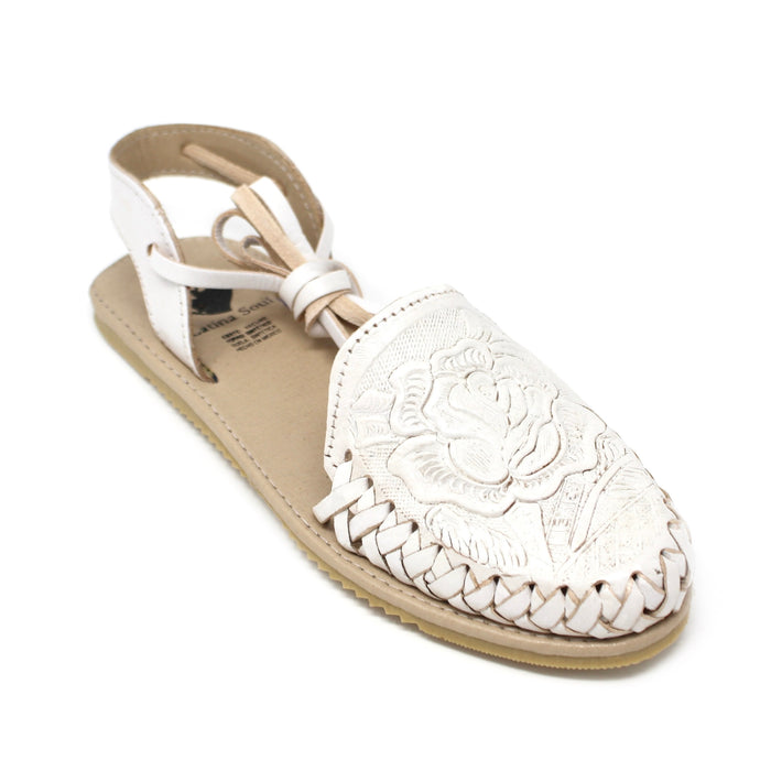 White sandal with floral lace design on a white background