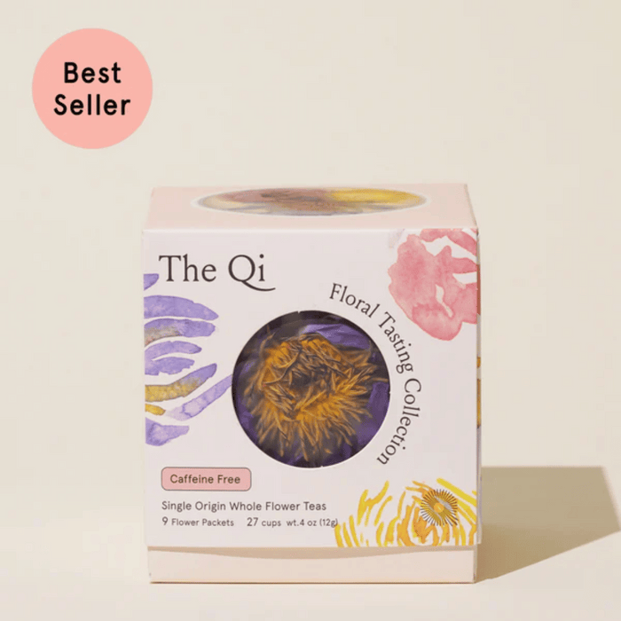 Packaging of "Floral Collection (Variety Box) | The Qi" featuring a circular window displaying dried flowers inside, labeled as caffeine free with colorful floral illustrations and a best seller badge.