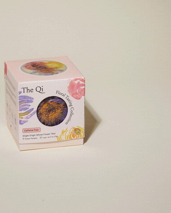 Packaging of the Floral Collection (Variety Box) | The Qi featuring colorful floral illustrations and a peek window showing dried whole flower teas for a caffeine-free, premium tea experience.