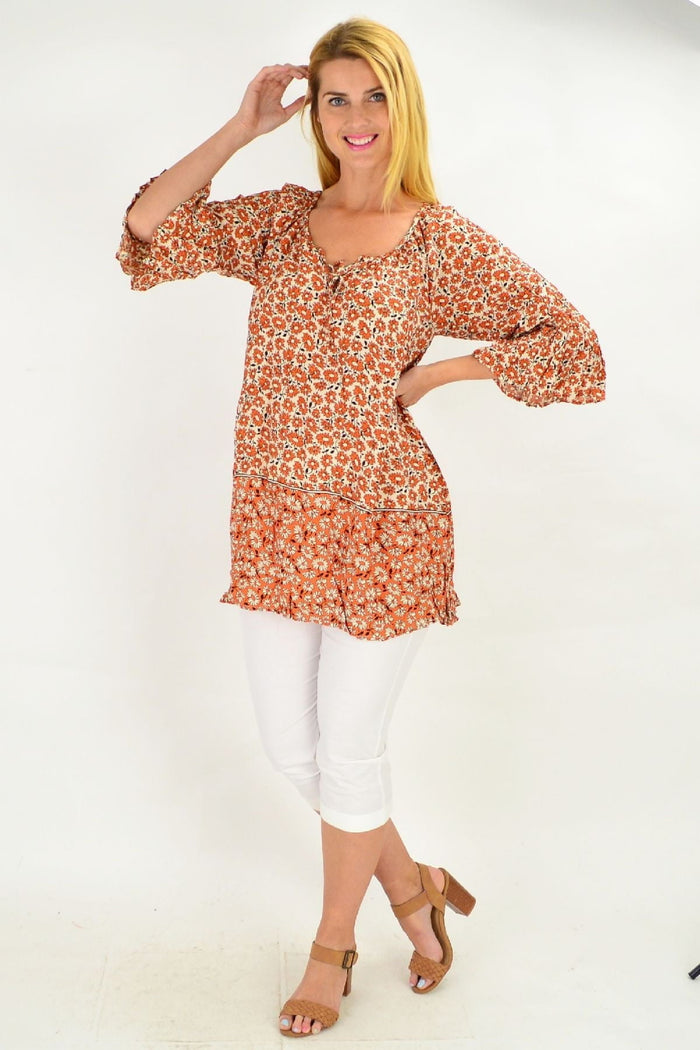 Hourglass Fresh Orange Flower Crinkle Tunic Top with floral pattern, lightweight fabric, and relaxed fit on a mannequin.