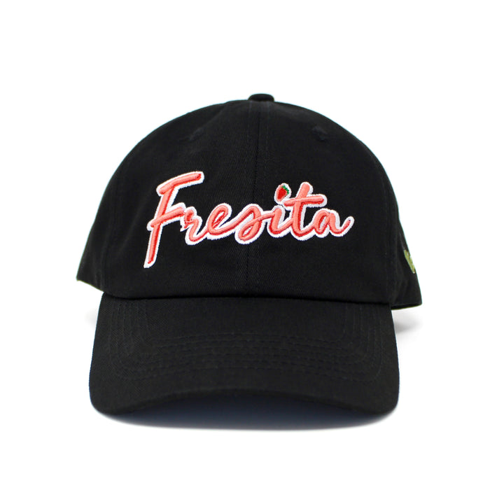 Front view of Black Fresita Dad Hat with embroidered red script and small strawberry detail on the letter i