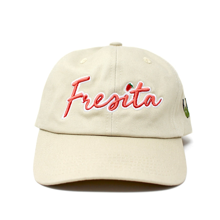 Front view of Khaki Fresita Dad Hat with embroidered red script and small strawberry detail on the letter i