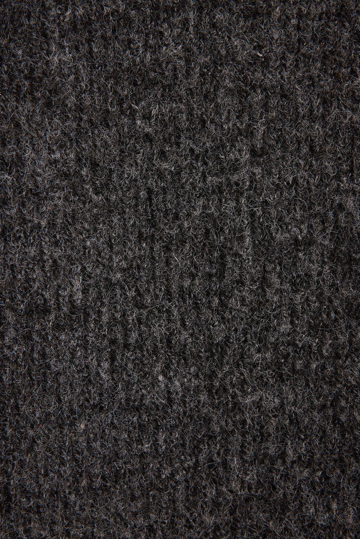 Lifestyle shot of the sweater styled for day-to-night versatility.