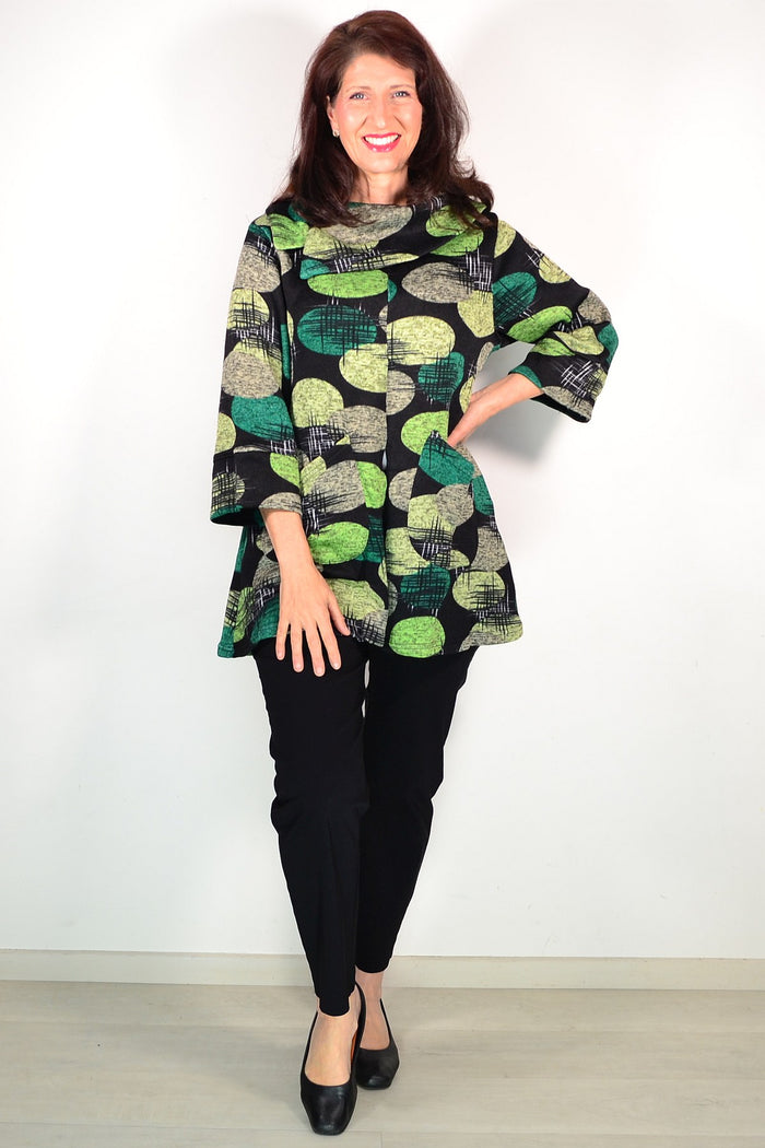Green Spots Winter Tunic Top by Wishstone, featuring a cozy fabric with green spotted pattern and long sleeves.