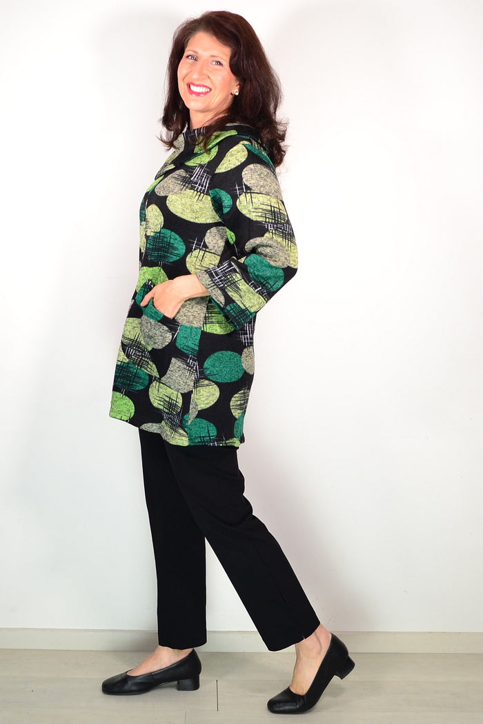 Wishstone green spots winter tunic top with long sleeves and a relaxed fit, styled on a hanger against a neutral background.