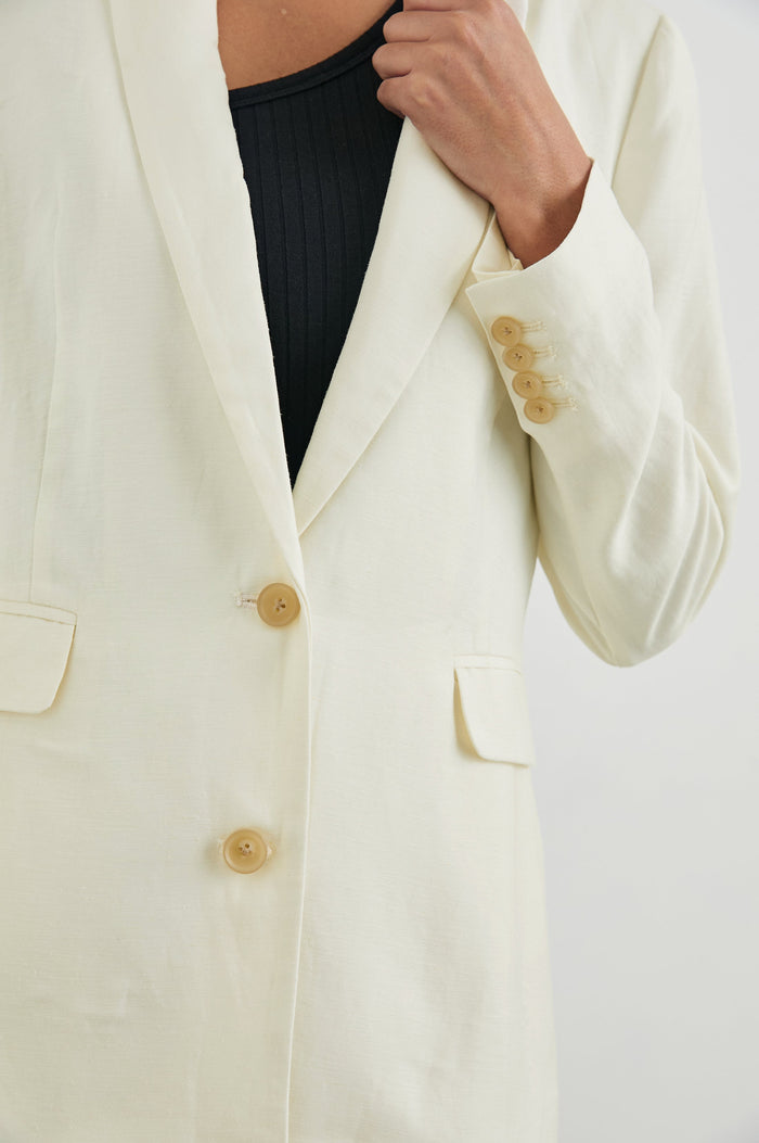 Lucienne Jacket with Two Button Closure, Two Front Flap Pockets, Four-Button Cuffs and Notched Lapels in Lotus Colorway - Front View Featured on Model
