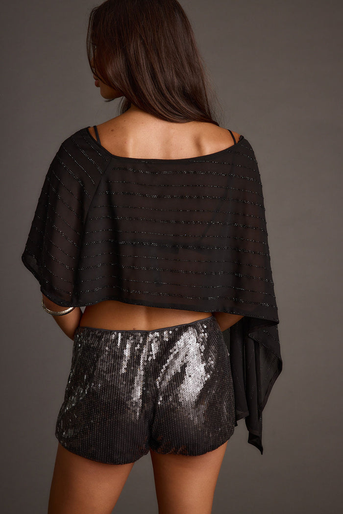 Lifestyle shot of the black piece styled for day-to-night versatility.