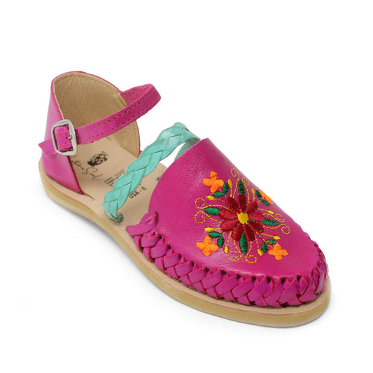 Women’s fuchsia fuchsia pink Mexican huarache sandals with colorful floral embroidery, turquoise braided strap and adjustable ankle buckle