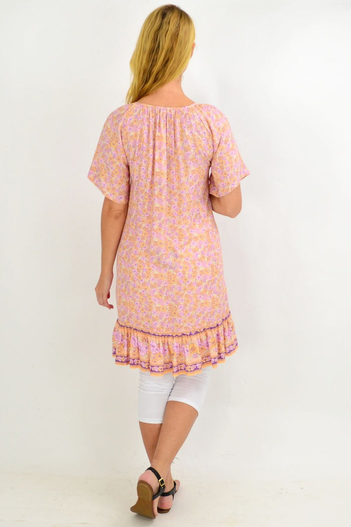 Baby pink floral tunic top from New U Collection with flowy fabric and relaxed fit, perfect for summer days.