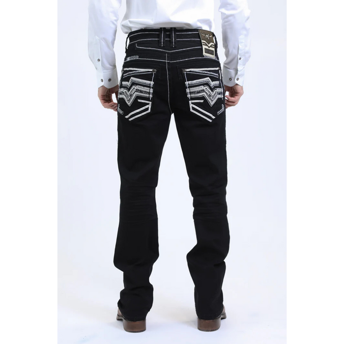 Black jeans with decorative patterns on the back pockets worn by a person on a white background