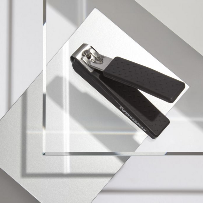 Precision Grip Toenail Clipper | Tweezerman with textured black handles designed for comfortable, precise toenail grooming, displayed on a clean, modern surface.