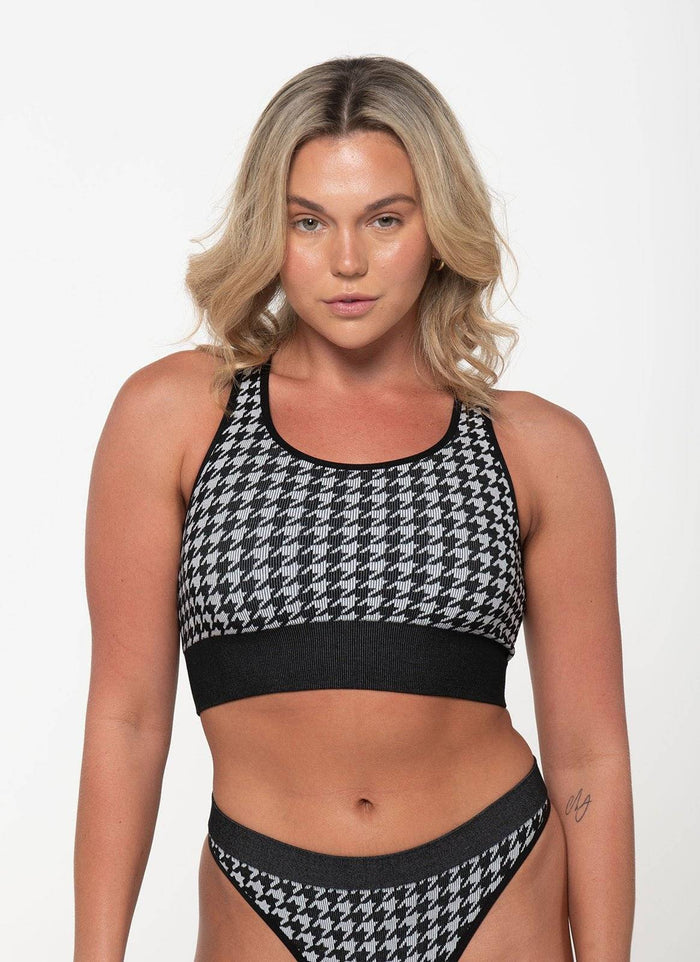 woman wearing black and white houndstooth racerback tank top and matching underwear set