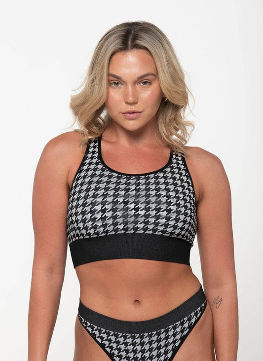 woman wearing black and white houndstooth racerback tank top and matching underwear set