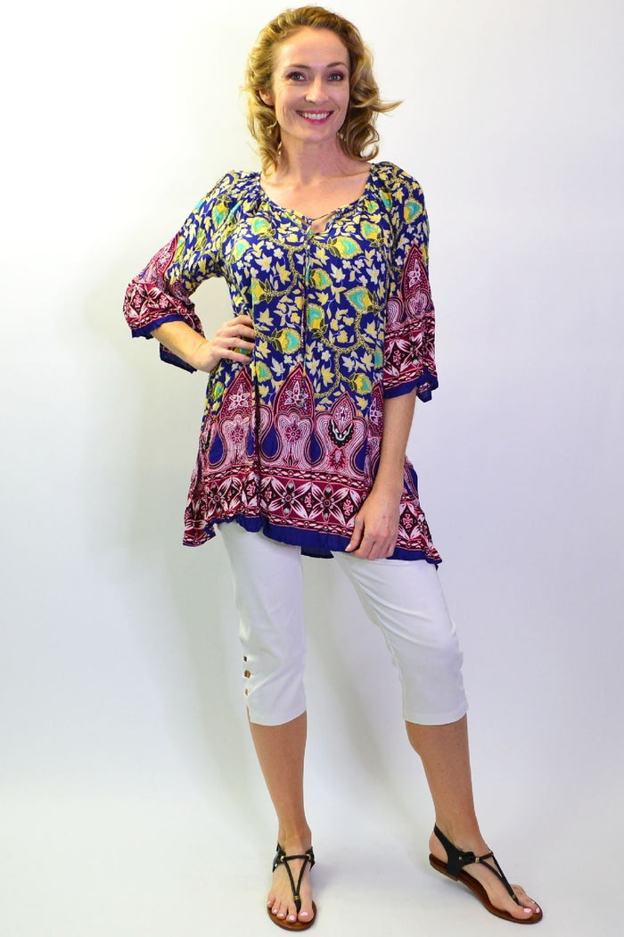Hourglass Rajasthani Palace Crinkle Tunic Top displayed on a hanger with intricate patterns and vibrant colors