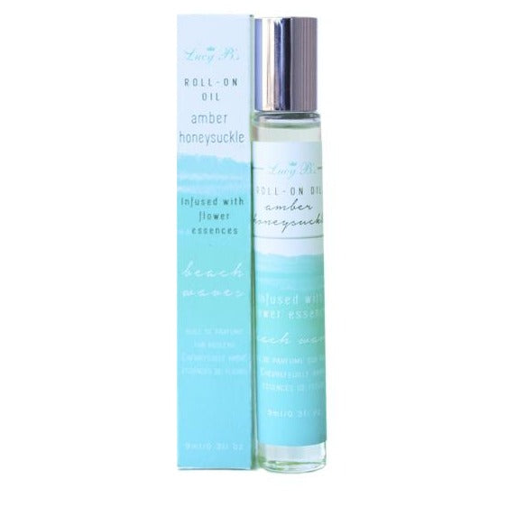 Roll-on Oil - Beach Waves Amber & Honeysuckle | Hydra Bloom in a clear glass bottle with silver cap alongside its blue and white packaging, promoting skincare and wellness with floral essences.