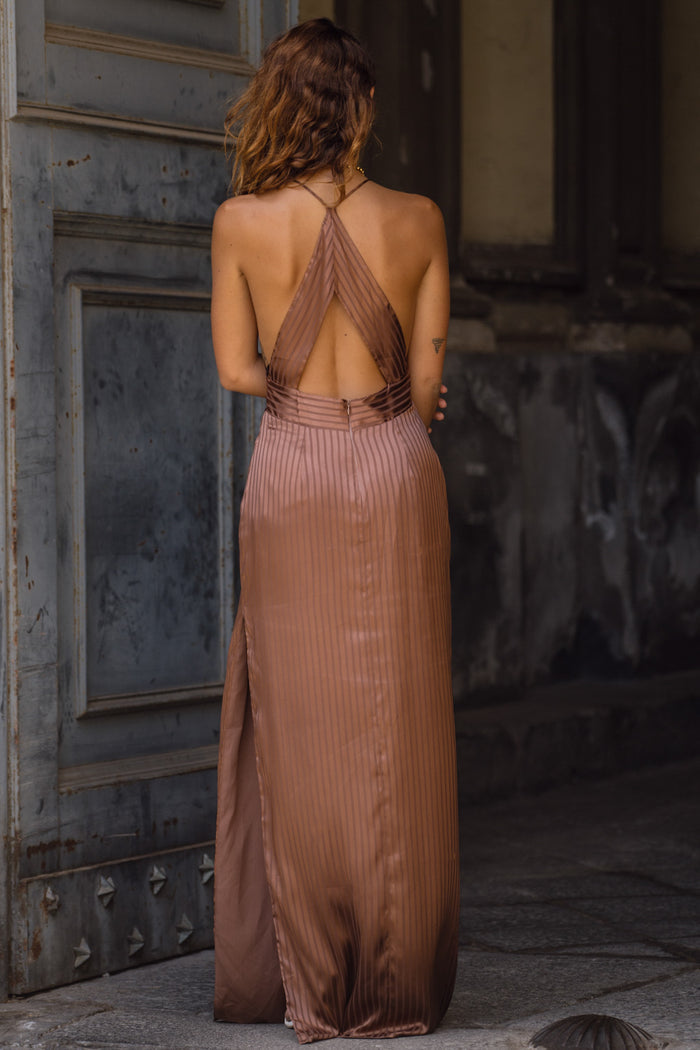 Full-length view of the striped maxi dress showing the drape and movement.