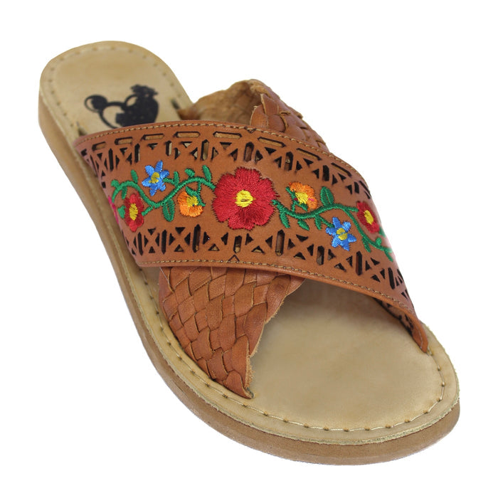 Women’s tan Mexican leather slide sandals with colorful floral embroidery, decorative cutouts and braided crossover strap