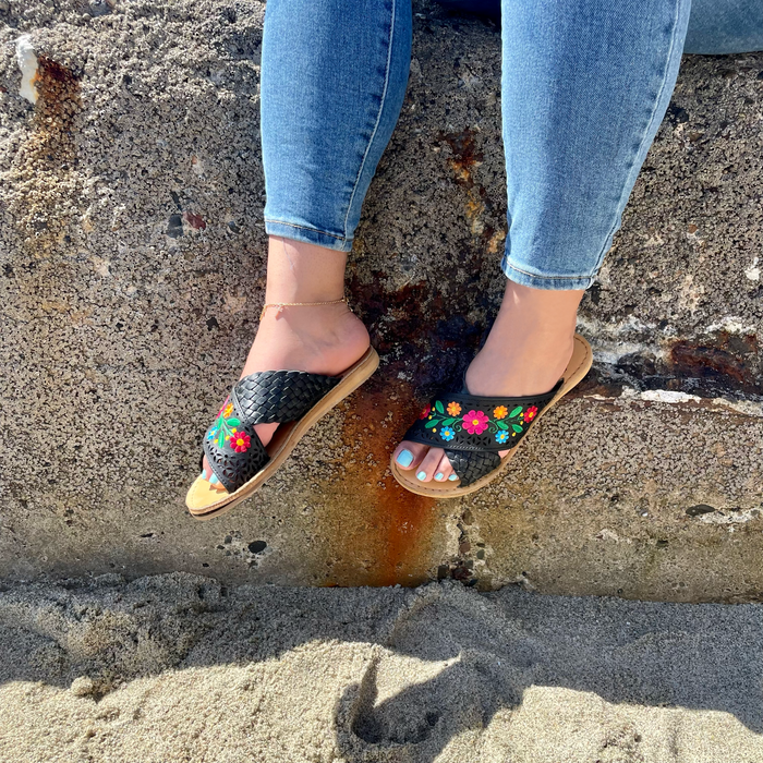 Women’s Mexican leather slide sandals with colorful floral embroidery, decorative cutouts and braided crossover strap