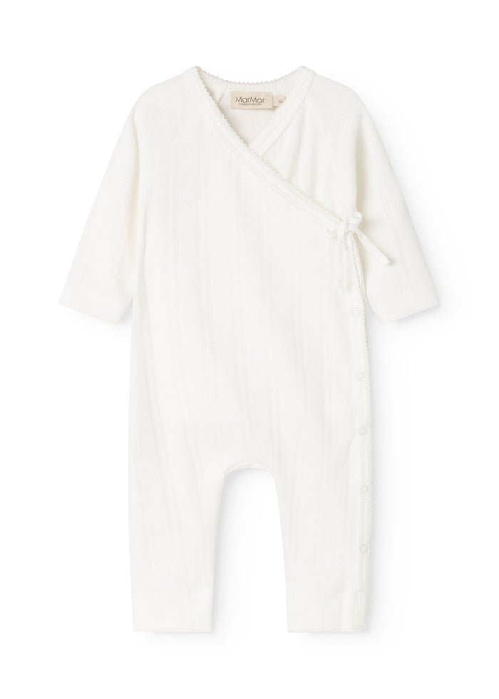 White baby romper with cross-over front and lace detail at the neckline.