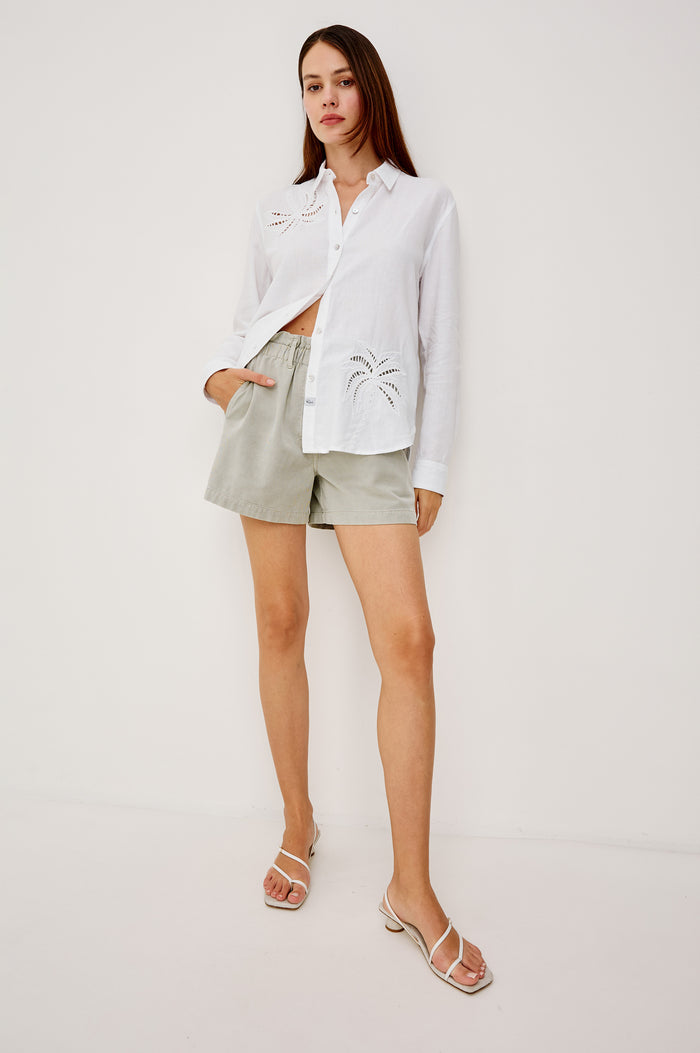 Samar Button-Up Collared Shirt in Linen With Palm Tree Eyelet Embroidery, Relaxed Fit, and Long Sleeves in White Palm Embroidery Colorway - Full Body Front View Featured on Model