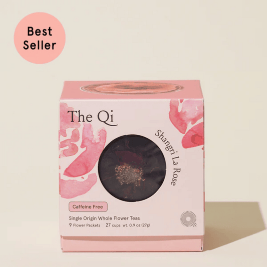 Packaging of Shangri-La Rose | The Qi caffeine-free single origin whole flower tea with pink floral design and a window showing the tea inside labeled as best seller
