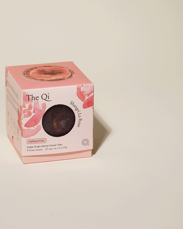 Box of Shangri-La Rose | The Qi caffeine-free single origin whole flower tea with visible dried rose buds inside, presented on a light background for wellness and body care.