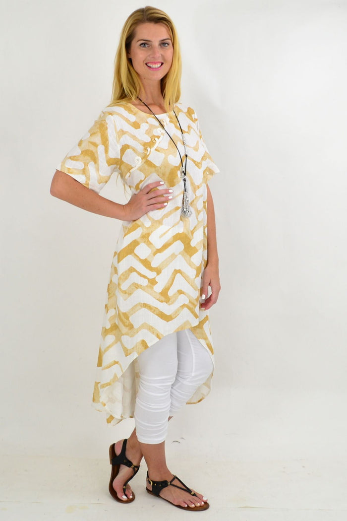 Beige tribal print linen mix hi-low hem tunic by Ruby Rain, featuring a relaxed fit and boho-inspired design.