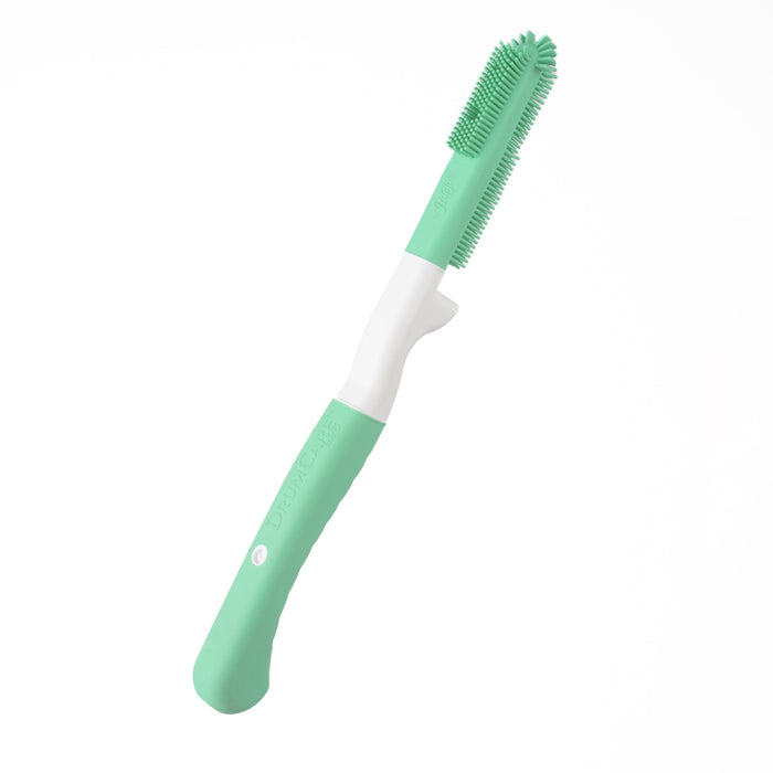 Green and white silicone brush on a white background